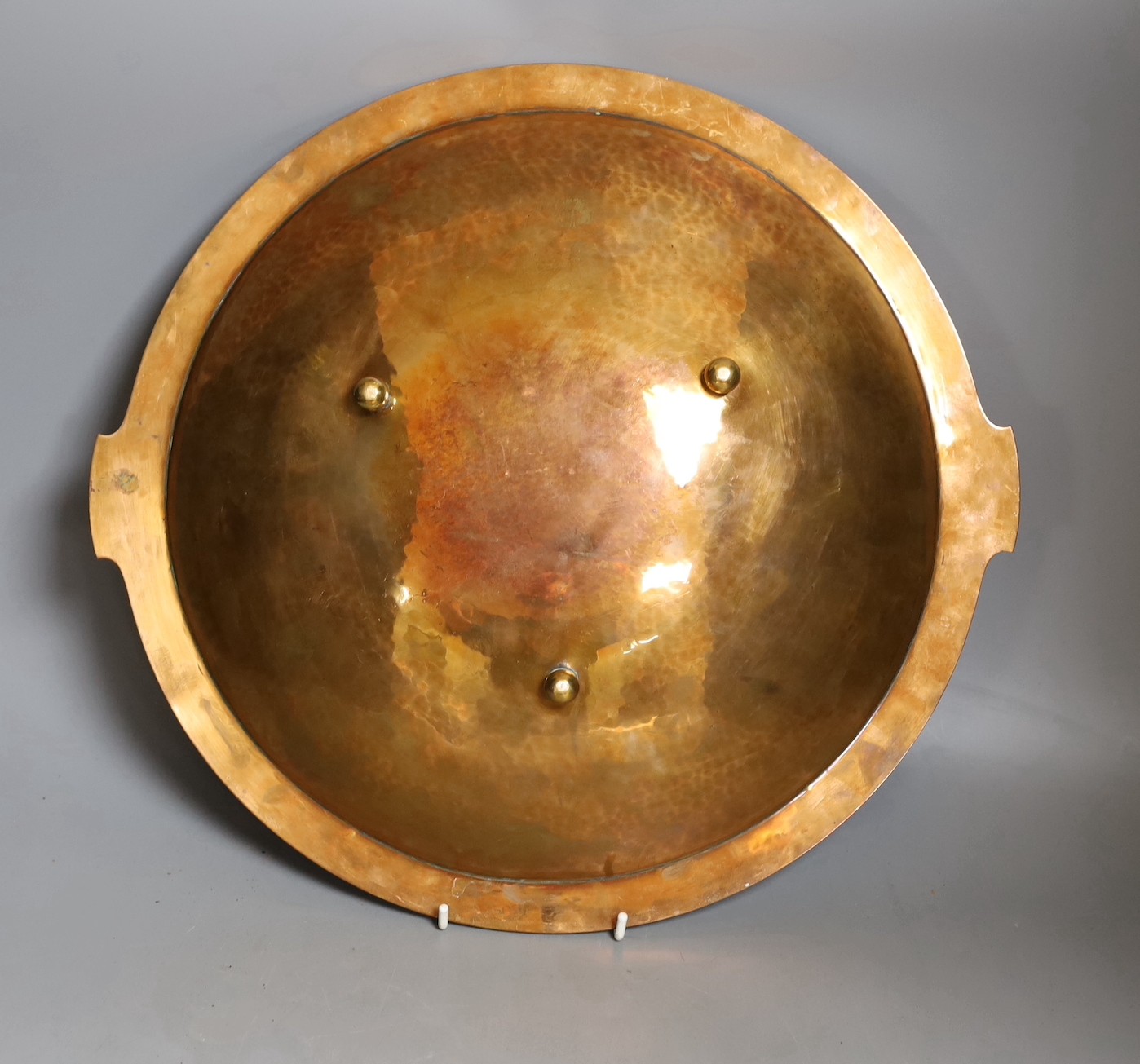 An early 20th century enamelled copper dish, on three ball feet, Tiffany style - 40cm diameter